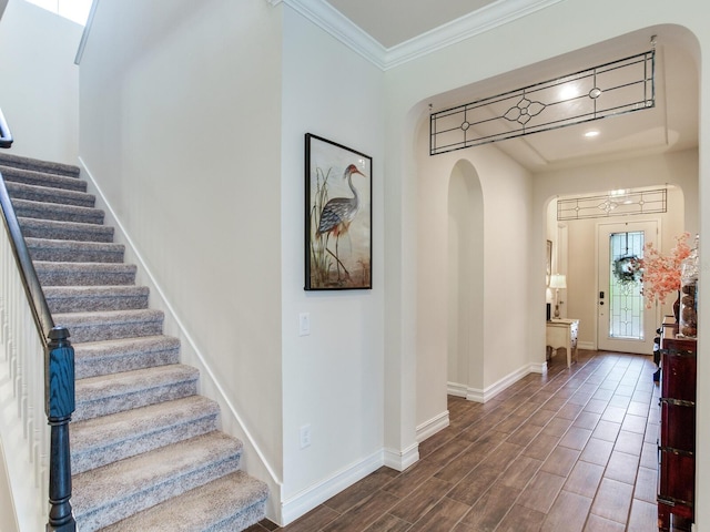 entrance foyer with dark hardwood / wood-style floors and crown molding