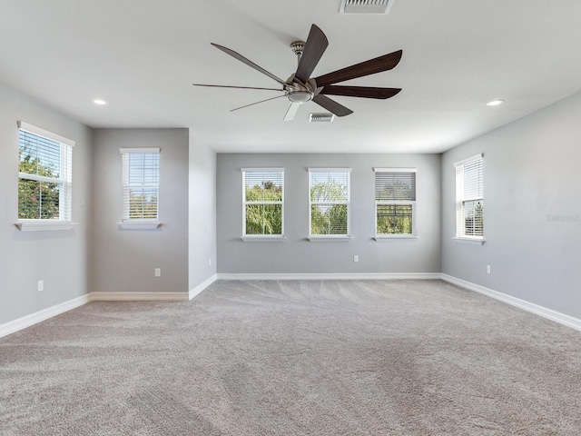 carpeted empty room featuring ceiling fan