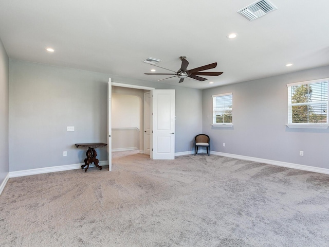 unfurnished bedroom with light carpet and ceiling fan