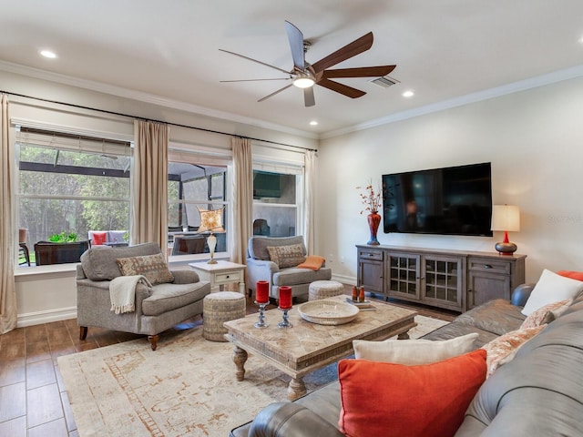 living room with light wood-type flooring, ceiling fan, and crown molding