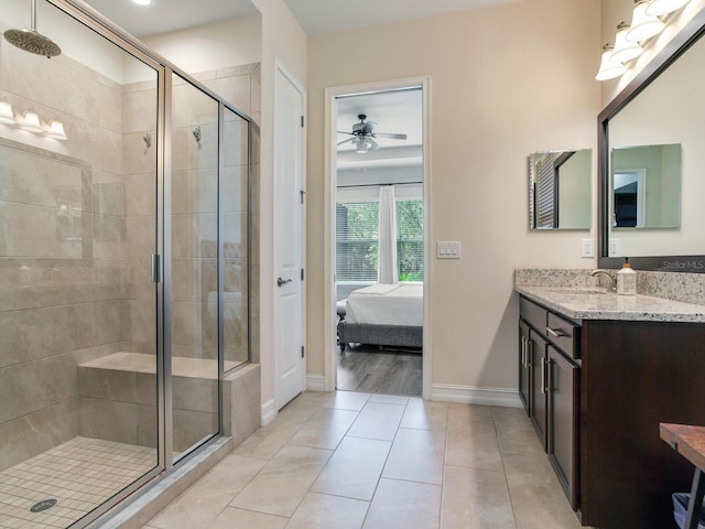 bathroom with ceiling fan, vanity, and a shower with door