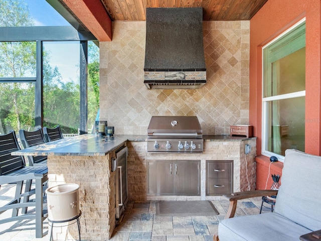 view of patio featuring area for grilling and a grill