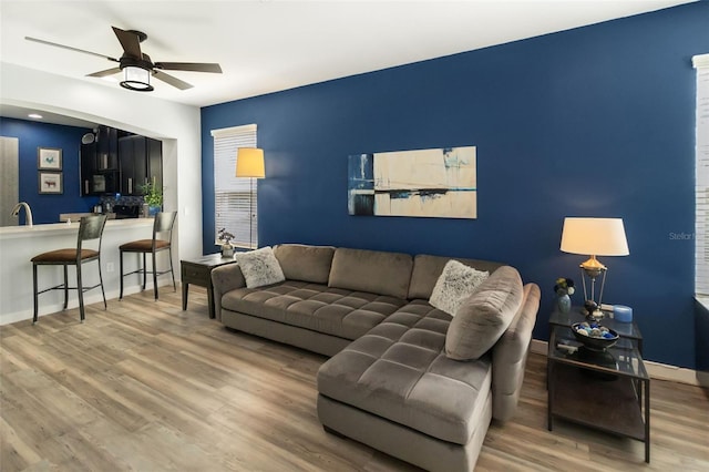 living room with ceiling fan, hardwood / wood-style flooring, and sink