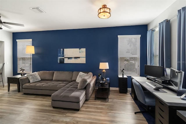 home office with wood-type flooring and ceiling fan