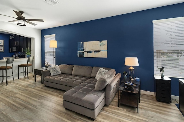 living room with ceiling fan and hardwood / wood-style floors