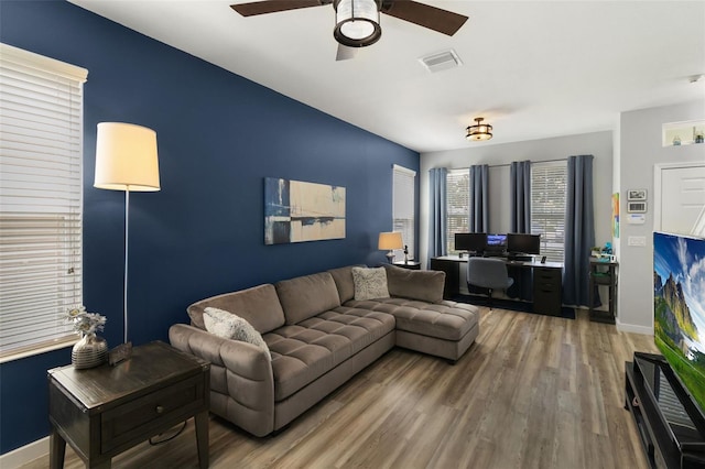 living room featuring ceiling fan and hardwood / wood-style flooring