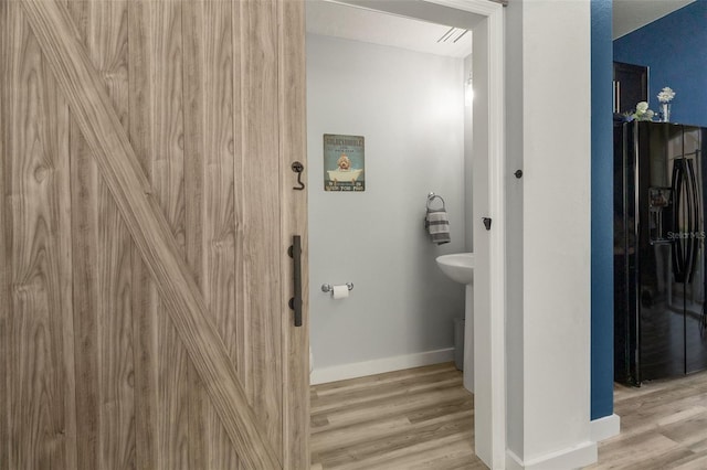 bathroom with wood-type flooring