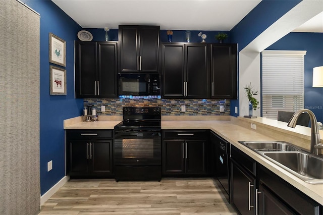 kitchen featuring light hardwood / wood-style flooring, sink, tasteful backsplash, and black appliances