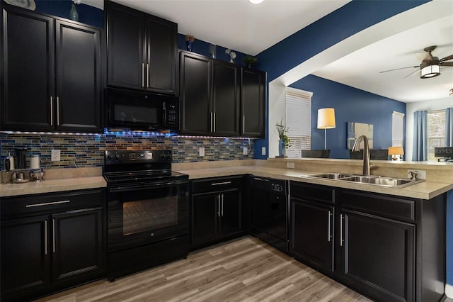 kitchen featuring kitchen peninsula, black appliances, ceiling fan, and sink