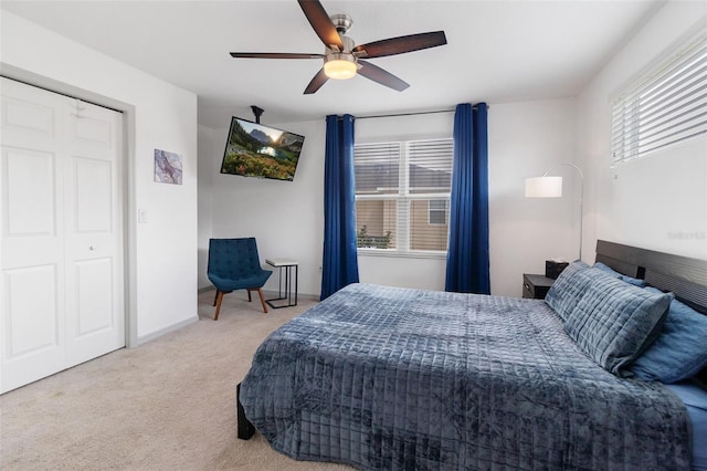 carpeted bedroom with ceiling fan and a closet