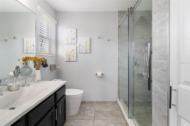 bathroom featuring vanity, toilet, and an enclosed shower