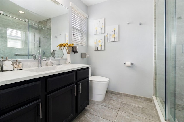 bathroom featuring an enclosed shower, vanity, and toilet