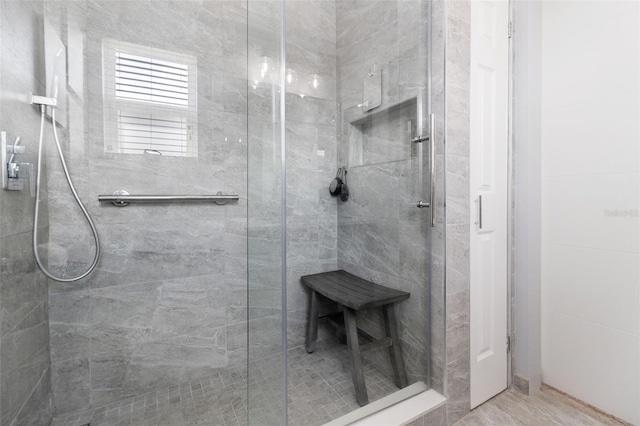 bathroom with a shower with shower door