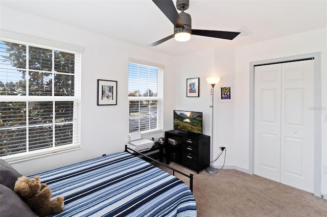 bedroom with carpet floors, a closet, and ceiling fan