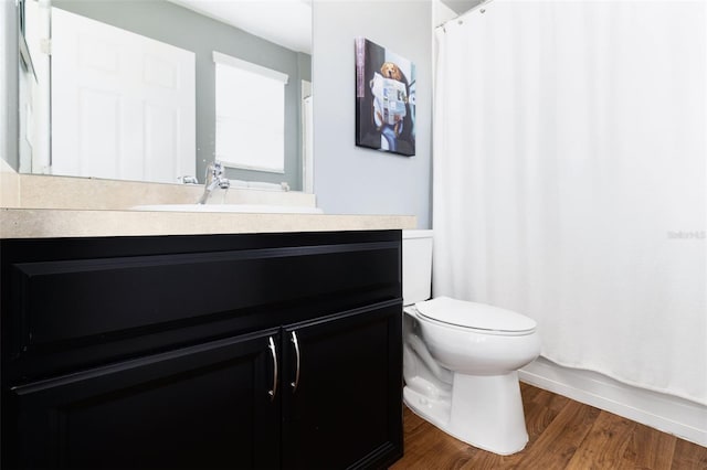 bathroom featuring walk in shower, vanity, toilet, and hardwood / wood-style flooring