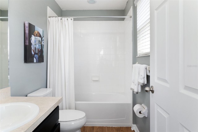 full bathroom with shower / tub combo with curtain, hardwood / wood-style flooring, vanity, and toilet