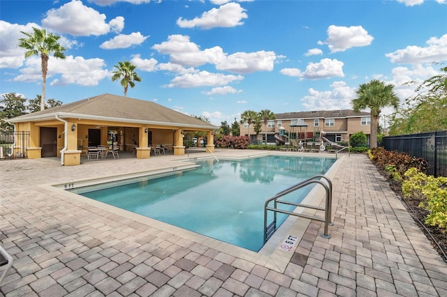 view of pool featuring a bar and a patio area