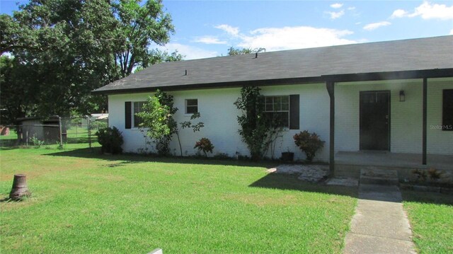 3225 Oakland Rd N, Lakeland, FL 33801 - exterior space featuring a front yard, fence, and brick siding