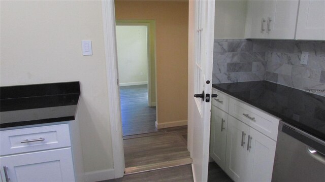 3225 Oakland Rd N, Lakeland, FL 33801 - kitchen featuring dishwasher, dark wood-style flooring, decorative backsplash, and dark countertops