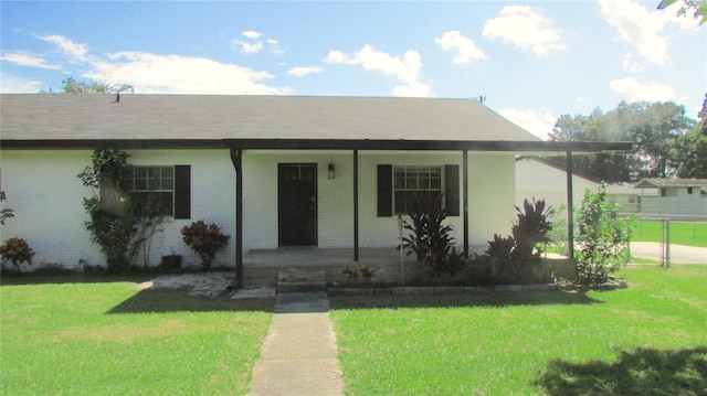 3225 Oakland Rd N, Lakeland, FL 33801 - view of front of property featuring covered porch, a front yard, and brick siding