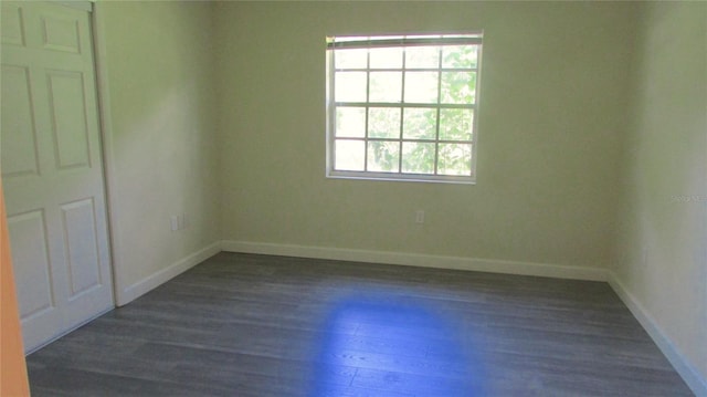 3225 Oakland Rd N, Lakeland, FL 33801 - spare room with dark wood-style flooring and baseboards