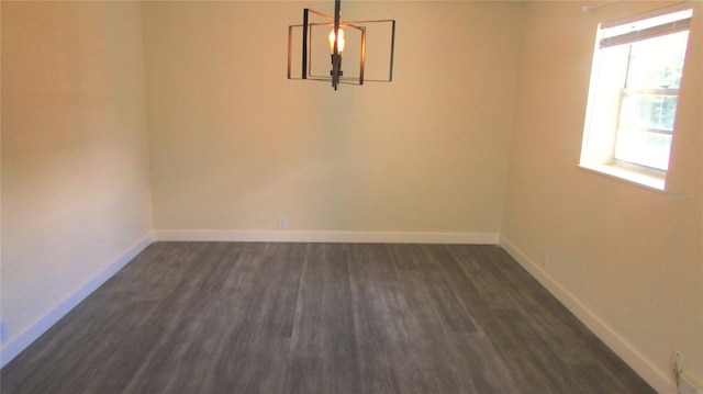 3225 Oakland Rd N, Lakeland, FL 33801 - unfurnished dining area with dark wood-style flooring, baseboards, and an inviting chandelier