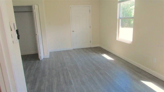 3225 Oakland Rd N, Lakeland, FL 33801 - unfurnished bedroom with wood finished floors and baseboards