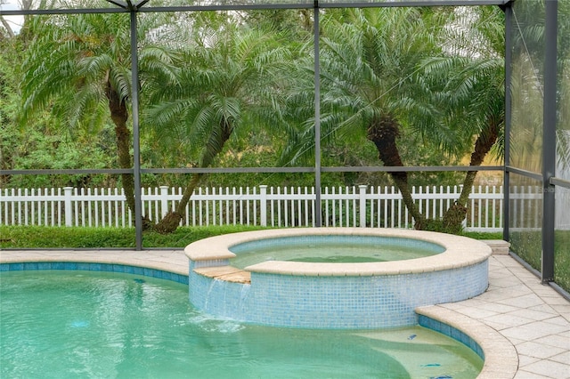 view of swimming pool with an in ground hot tub