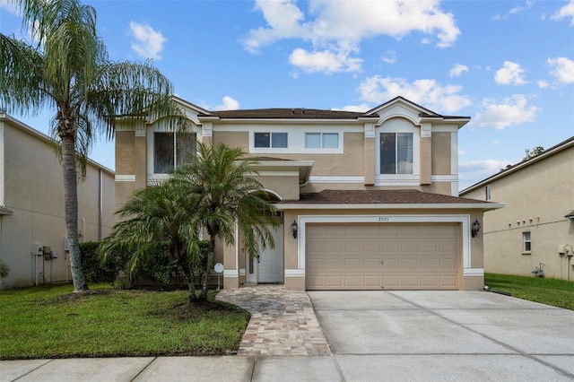 view of front of property featuring a garage and a front lawn