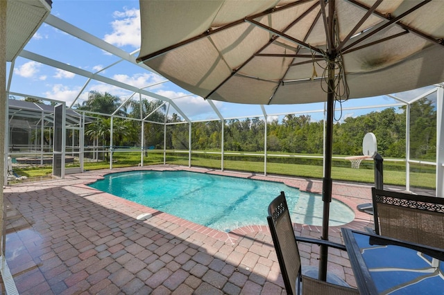 view of pool featuring a lawn, a lanai, and a patio