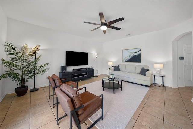 tiled living room featuring ceiling fan