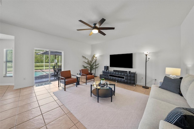 living room with ceiling fan and light tile patterned floors