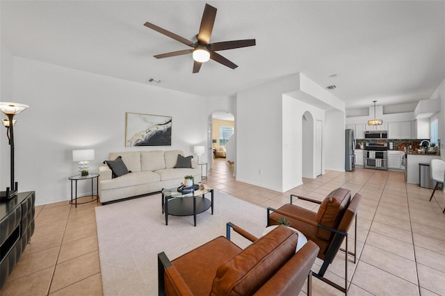 tiled living room featuring ceiling fan