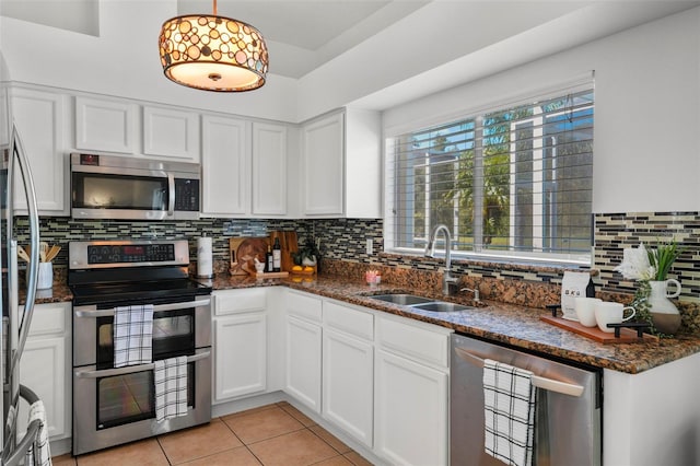 kitchen featuring pendant lighting, white cabinetry, sink, and appliances with stainless steel finishes