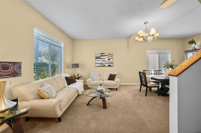 living room with light colored carpet and a notable chandelier