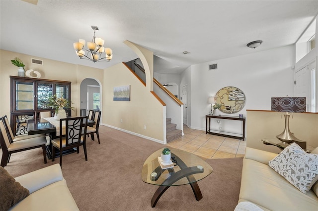 living room with a notable chandelier and light tile patterned floors