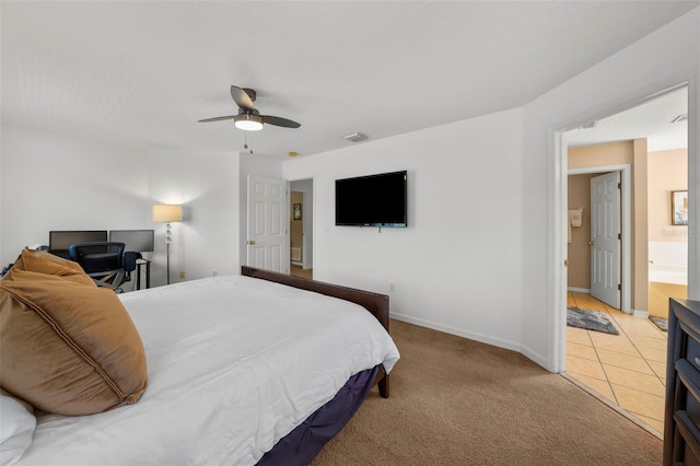 carpeted bedroom featuring ensuite bath and ceiling fan