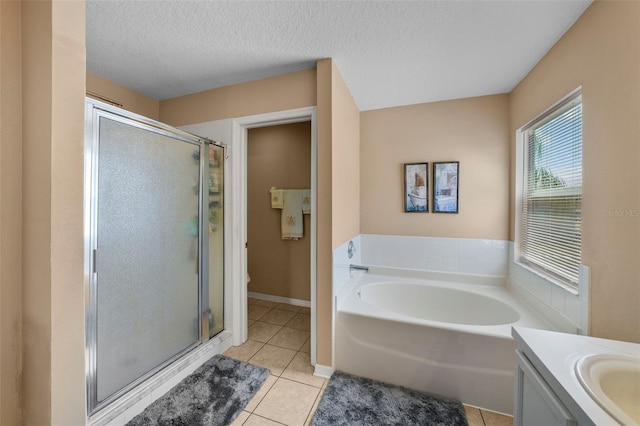 full bathroom featuring tile patterned flooring, vanity, a textured ceiling, and independent shower and bath