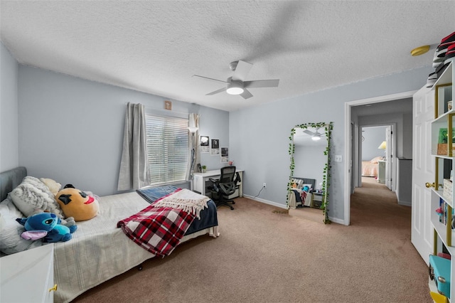 bedroom featuring carpet flooring, ceiling fan, and a textured ceiling