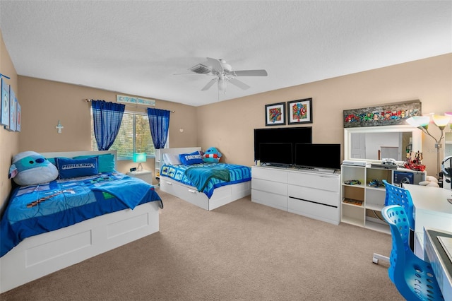 carpeted bedroom with ceiling fan and a textured ceiling