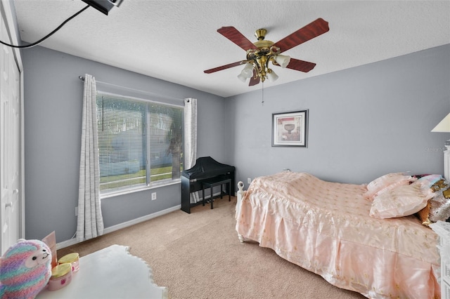 carpeted bedroom with ceiling fan and a textured ceiling