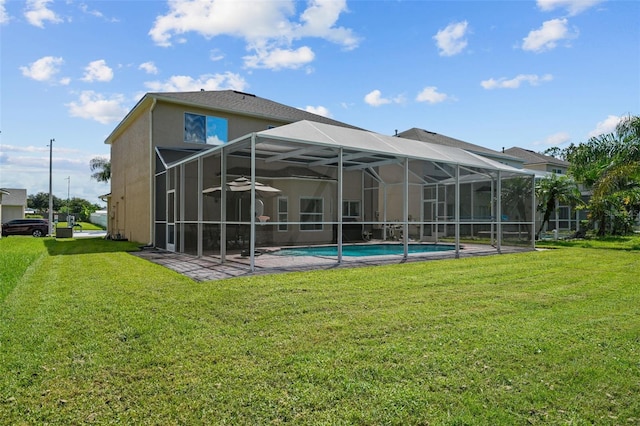 back of property with a lanai and a yard