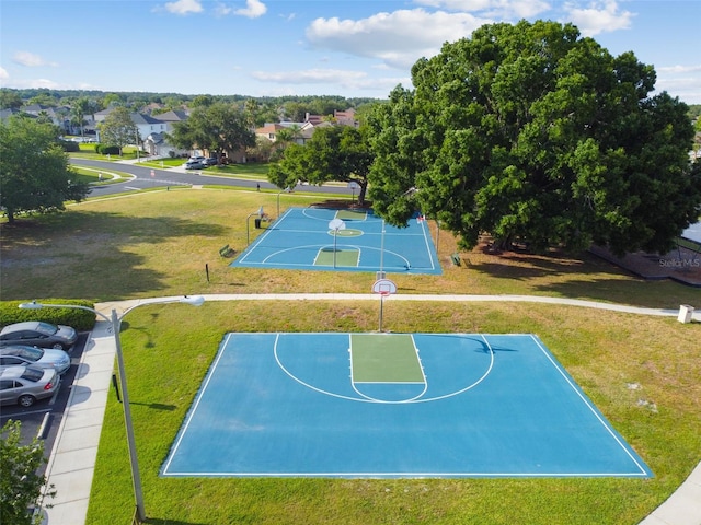 view of basketball court with a lawn