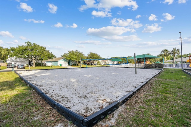 view of home's community featuring a lawn and volleyball court