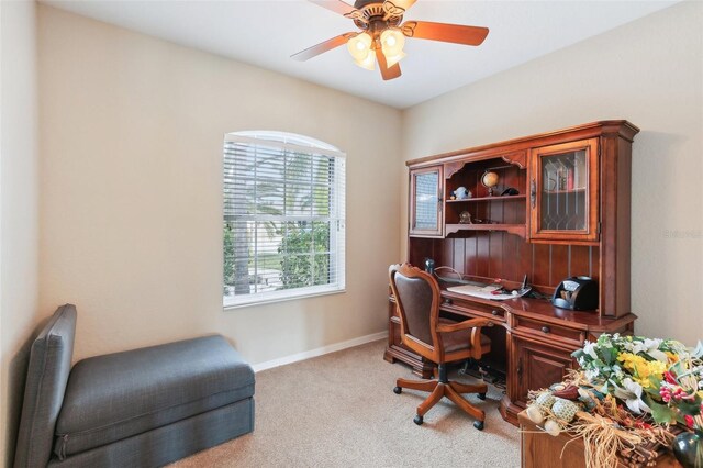 home office featuring light colored carpet and ceiling fan