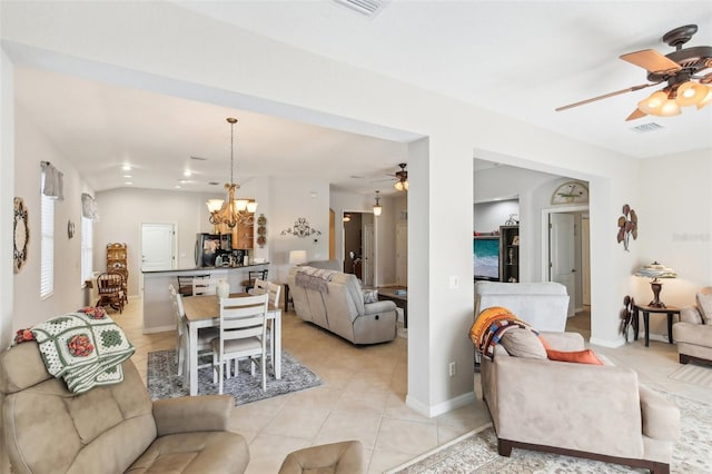 tiled living room with ceiling fan with notable chandelier