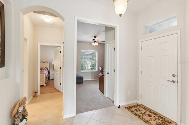 entryway featuring ceiling fan and light tile patterned floors