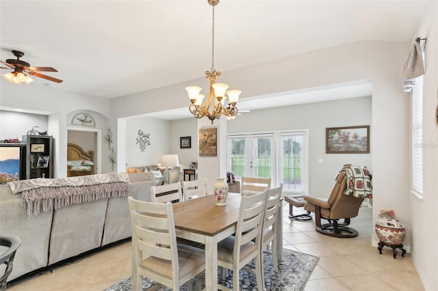 tiled dining area featuring ceiling fan with notable chandelier