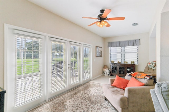 interior space with ceiling fan