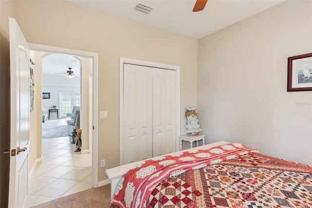 tiled bedroom featuring a closet and ceiling fan